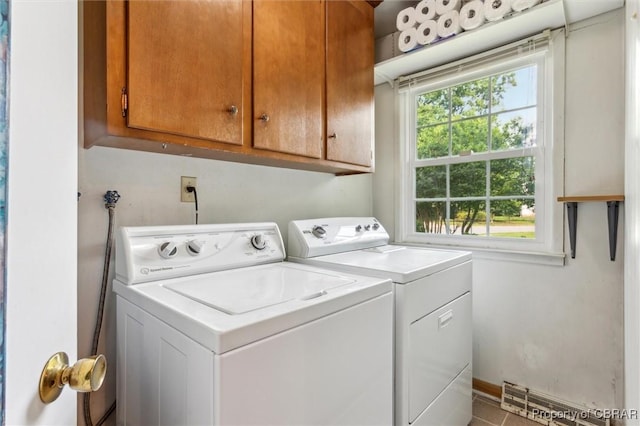1 Beacon Cir, Hampton, VA 23664 - laundry area featuring cabinet space, washing machine and dryer, tile patterned floors, and a baseboard radiator