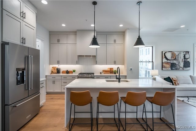 425 W 7th St, Richmond, VA 23224 - kitchen with high quality appliances, a sink, a breakfast bar area, light countertops, and recessed lighting
