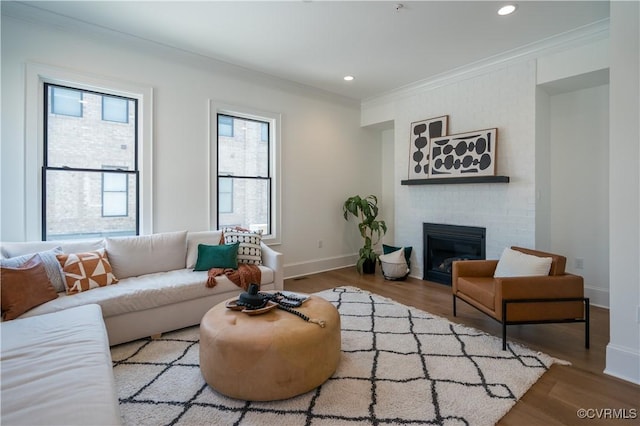 425 W 7th St, Richmond, VA 23224 - living area with crown molding, wood finished floors, baseboards, a brick fireplace, and recessed lighting