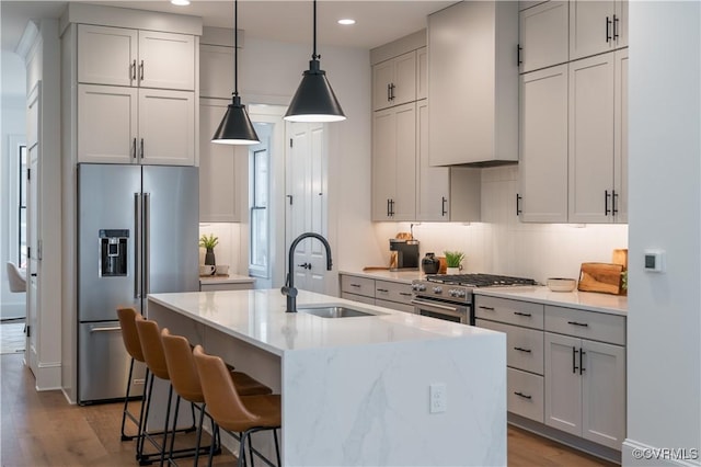 425 W 7th St, Richmond, VA 23224 - kitchen with premium appliances, premium range hood, a sink, decorative backsplash, and recessed lighting