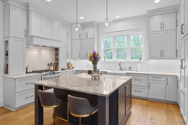 547 River Rd, Manakin Sabot, VA 23103 - kitchen featuring recessed lighting, light stone countertops, a breakfast bar area, a center island, and decorative backsplash