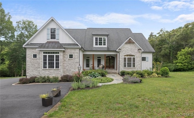 547 River Rd, Manakin Sabot, VA 23103 - view of front of house with stone siding, covered porch, a front lawn, and board and batten siding