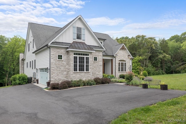 547 River Rd, Manakin Sabot, VA 23103 - view of front of property featuring stone siding, board and batten siding, asphalt driveway, an attached garage, and a standing seam roof