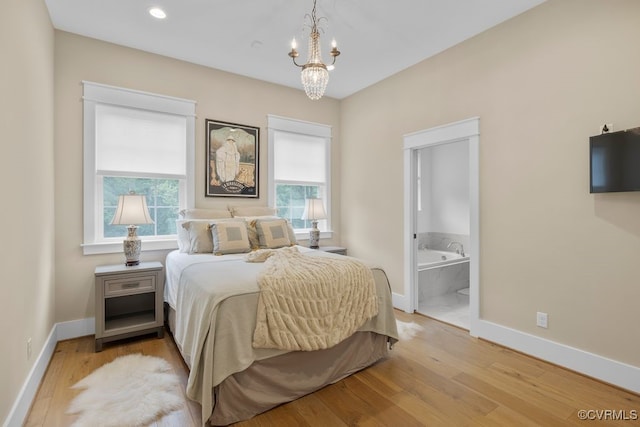 547 River Rd, Manakin Sabot, VA 23103 - bedroom with light wood-type flooring, a chandelier, and ensuite bathroom