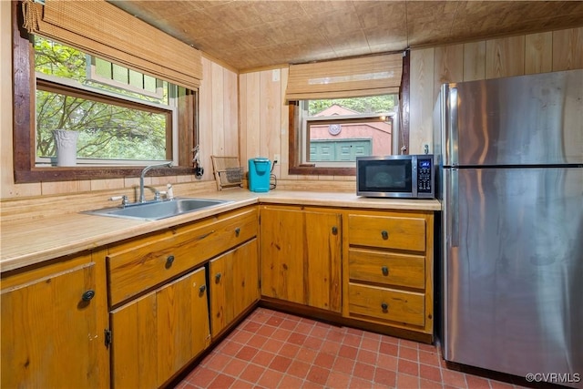 198 Trices Lake Rd, Columbia, VA 23038 - kitchen with stainless steel appliances, a sink, light countertops, plenty of natural light, and wood walls