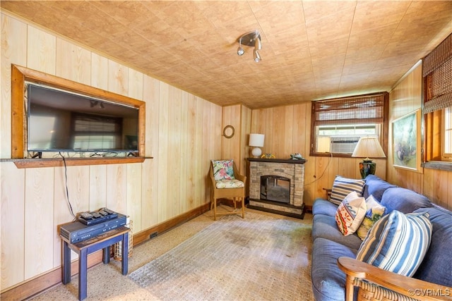 198 Trices Lake Rd, Columbia, VA 23038 - living area with wood walls, a glass covered fireplace, baseboards, and cooling unit