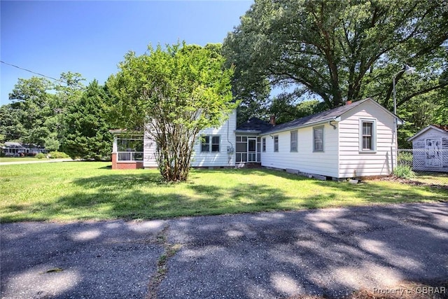 708 Calthrop Neck Rd, Yorktown, VA 23693 - view of front of property with a sunroom and a front yard