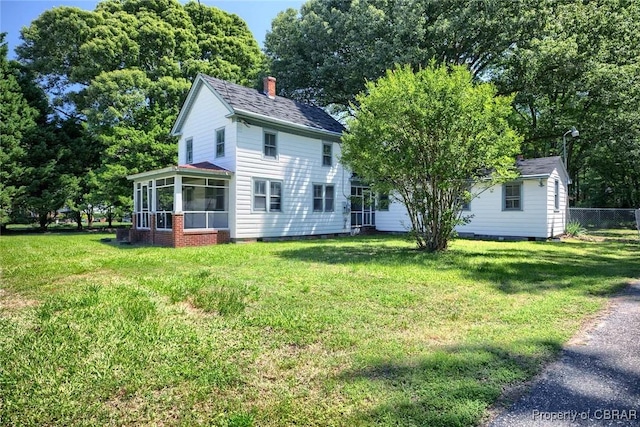 708 Calthrop Neck Rd, Yorktown, VA 23693 - rear view of property with a sunroom and a chimney