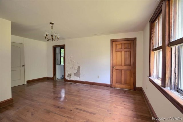 708 Calthrop Neck Rd, Yorktown, VA 23693 - empty room with plenty of natural light, a chandelier, and wood finished floors