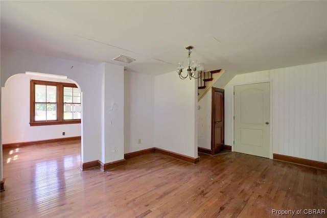 708 Calthrop Neck Rd, Yorktown, VA 23693 - unfurnished dining area with a chandelier, wood finished floors, and arched walkways