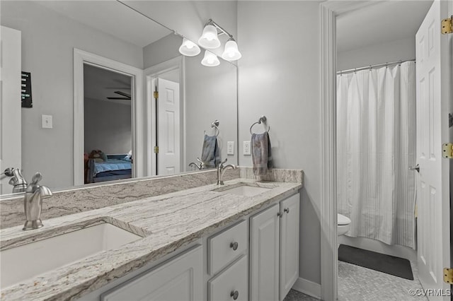 14469 St Andrews Ln, Ashland, VA 23005 - bathroom featuring connected bathroom, double vanity, toilet, baseboards, and a shower with shower curtain