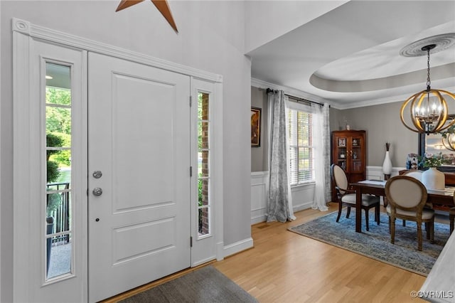 14469 St Andrews Ln, Ashland, VA 23005 - entryway featuring a chandelier, a decorative wall, light wood-style flooring, crown molding, and wainscoting