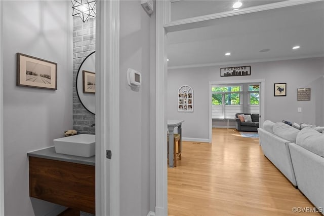14469 St Andrews Ln, Ashland, VA 23005 - hall with ornamental molding, light wood-type flooring, a sink, baseboards, and recessed lighting