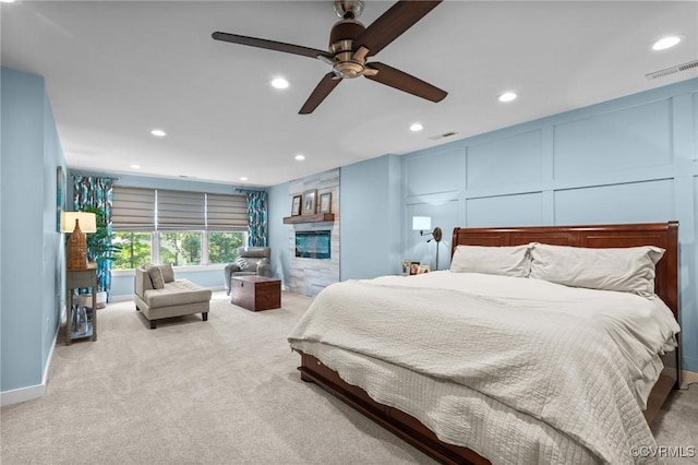 14469 St Andrews Ln, Ashland, VA 23005 - bedroom with a decorative wall, carpet flooring, recessed lighting, a large fireplace, and a ceiling fan