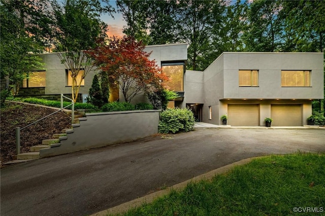 322 Charmian Rd, Richmond, VA 23226 - modern home with stairs, driveway, a garage, and stucco siding