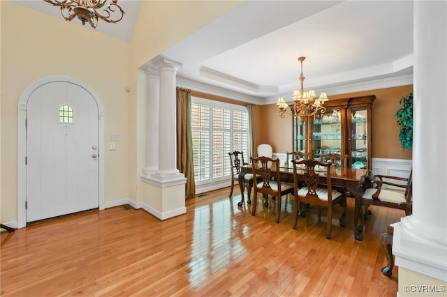 561 Hill Grove Rd, Manakin Sabot, VA 23103 - dining area with a chandelier, decorative columns, light wood-type flooring, a raised ceiling, and ornamental molding
