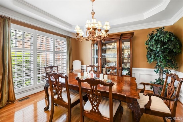 561 Hill Grove Rd, Manakin Sabot, VA 23103 - dining room featuring a tray ceiling, a chandelier, plenty of natural light, crown molding, and light wood finished floors