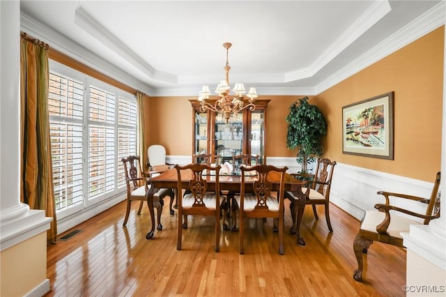 561 Hill Grove Rd, Manakin Sabot, VA 23103 - dining space with plenty of natural light, light wood finished floors, a chandelier, wainscoting, and ornamental molding