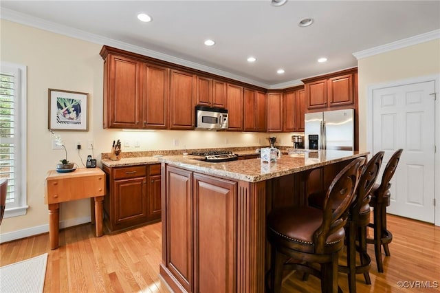 561 Hill Grove Rd, Manakin Sabot, VA 23103 - kitchen with stainless steel appliances, crown molding, light stone counters, light wood-type flooring, and a kitchen island