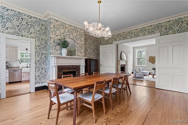 9341 Varina Rd, Henrico, VA 23231 - dining room with a fireplace, ornamental molding, wallpapered walls, light wood-style flooring, and a chandelier