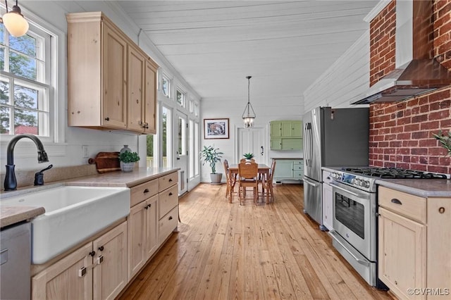 9341 Varina Rd, Henrico, VA 23231 - kitchen with wall chimney range hood, stainless steel appliances, a sink, light brown cabinets, and light wood finished floors