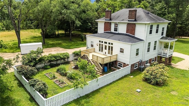 9341 Varina Rd, Henrico, VA 23231 - back of property with a chimney, stairway, central AC unit, a wooden deck, and a vegetable garden