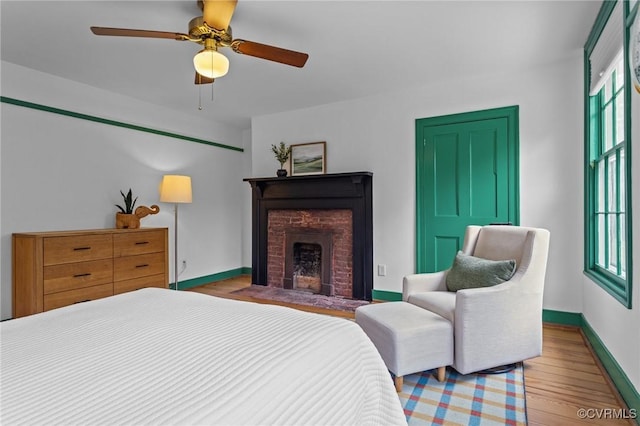 9341 Varina Rd, Henrico, VA 23231 - bedroom with wood finished floors, baseboards, a fireplace with flush hearth, and ceiling fan
