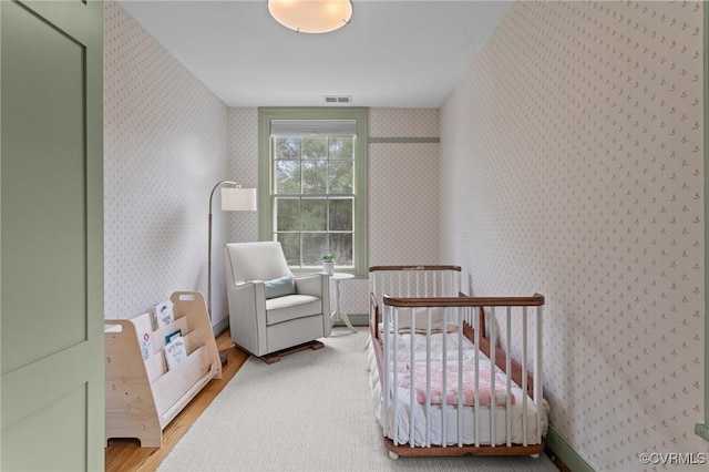 9341 Varina Rd, Henrico, VA 23231 - bedroom with wood finished floors, wallpapered walls, and a nursery area