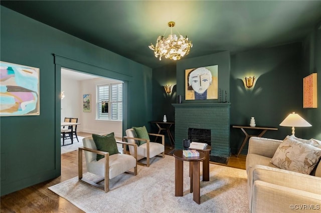 109 Libbie Ave, Richmond, VA 23226 - living room featuring a chandelier, wood finished floors, a fireplace, and baseboards