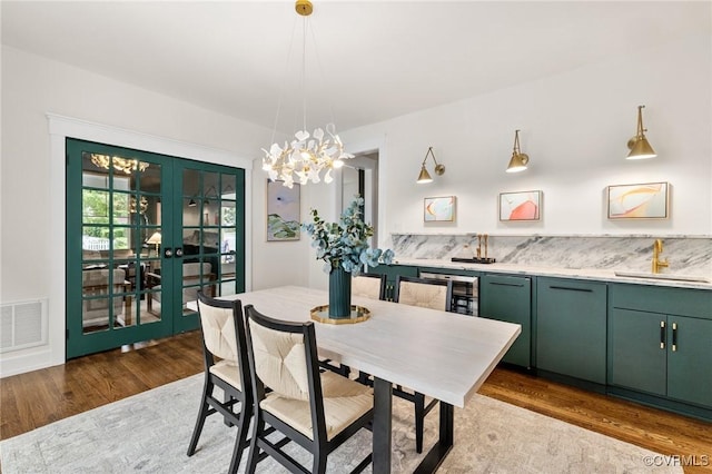 109 Libbie Ave, Richmond, VA 23226 - dining room with wood finished floors, a chandelier, french doors, and wine cooler