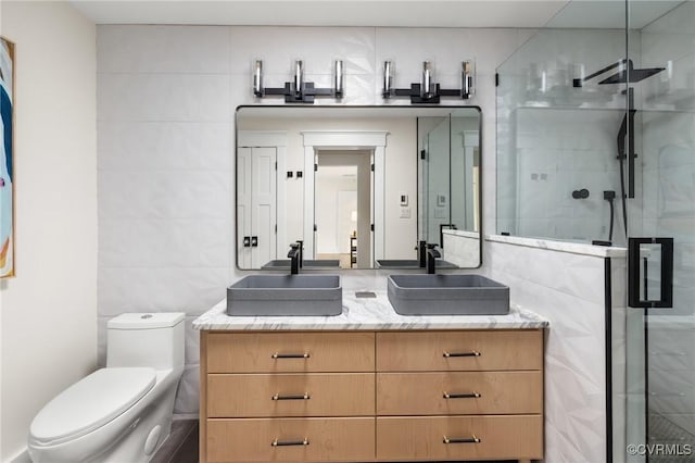 109 Libbie Ave, Richmond, VA 23226 - bathroom with tile walls, vanity, a shower stall, and toilet