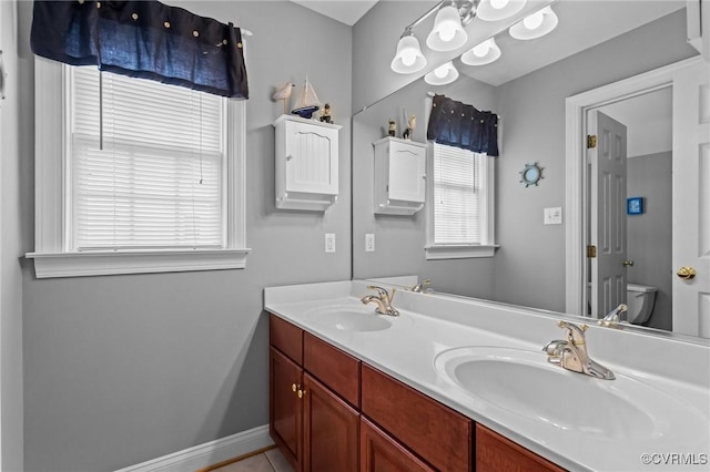 9085 Winter Spring Dr, Mechanicsville, VA 23116 - bathroom with double vanity, toilet, and baseboards