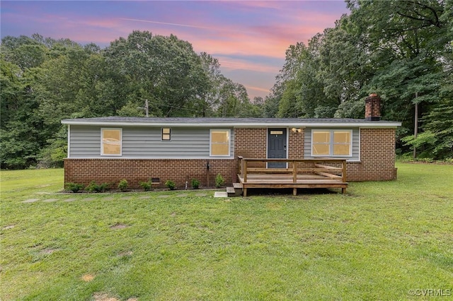 3027 Supply Rd, Port Royal, VA 22436 - view of front of home featuring brick siding, a wooden deck, a front lawn, and a chimney