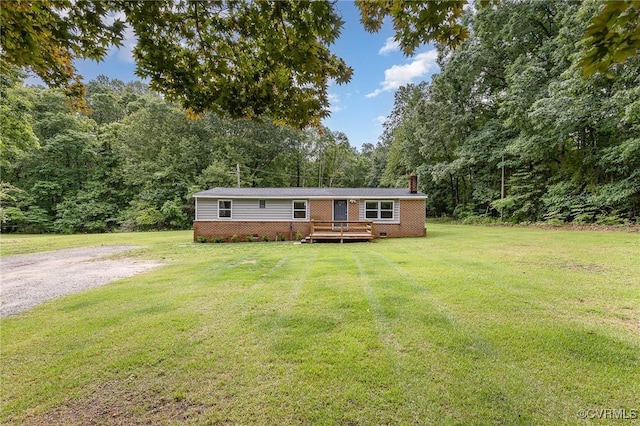 3027 Supply Rd, Port Royal, VA 22436 - manufactured / mobile home featuring a chimney, a wooden deck, crawl space, a front yard, and a view of trees