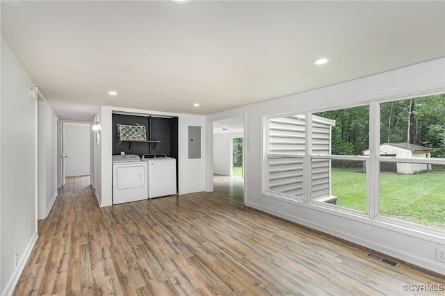3027 Supply Rd, Port Royal, VA 22436 - unfurnished living room featuring electric panel, separate washer and dryer, wood finished floors, baseboards, and recessed lighting