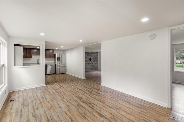 3027 Supply Rd, Port Royal, VA 22436 - unfurnished living room featuring wood finished floors, recessed lighting, baseboards, and a sink