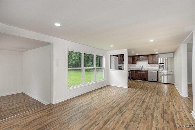 3027 Supply Rd, Port Royal, VA 22436 - unfurnished living room with a sink, wood finished floors, baseboards, and recessed lighting