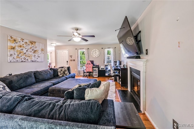 3218 Rimswell Ct, Midlothian, VA 23112 - living room featuring wood finished floors, a fireplace with flush hearth, a ceiling fan, and baseboards