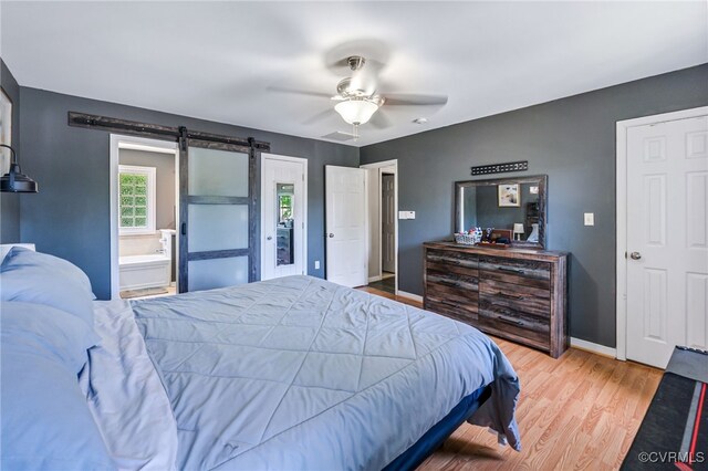 3218 Rimswell Ct, Midlothian, VA 23112 - bedroom with a barn door, wood finished floors, baseboards, ceiling fan, and connected bathroom
