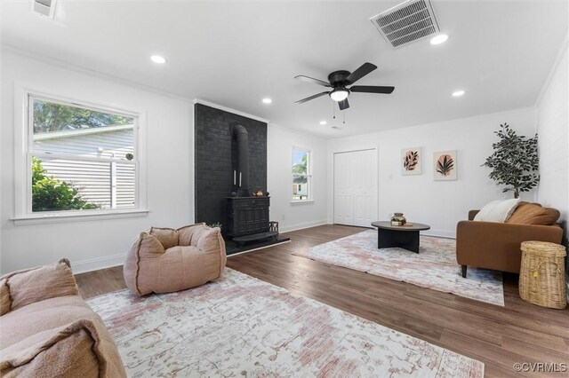 1311 Dinwiddie Ave, Hopewell, VA 23860 - living area featuring a wood stove, wood finished floors, ceiling fan, recessed lighting, and baseboards