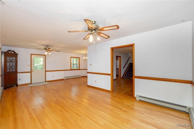 6495 Robin Way, Mechanicsville, VA 23111 - spare room featuring baseboard heating, ceiling fan, a baseboard radiator, light wood-type flooring, and stairway