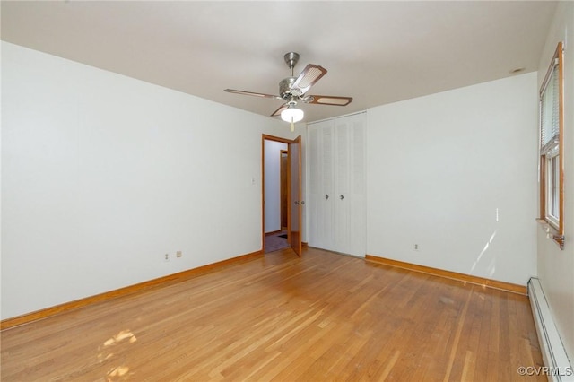 6495 Robin Way, Mechanicsville, VA 23111 - spare room featuring baseboard heating, light wood-style floors, a ceiling fan, and baseboards