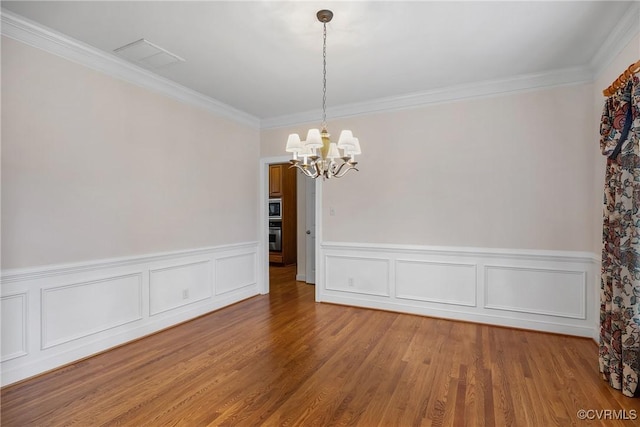 4905 Old Millrace Pl, Glen Allen, VA 23059 - unfurnished dining area with a chandelier, ornamental molding, wainscoting, and light wood-type flooring