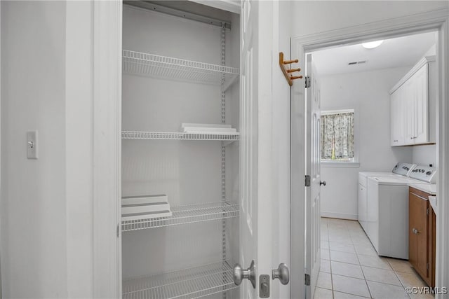 4905 Old Millrace Pl, Glen Allen, VA 23059 - laundry area featuring cabinet space, light tile patterned flooring, and independent washer and dryer