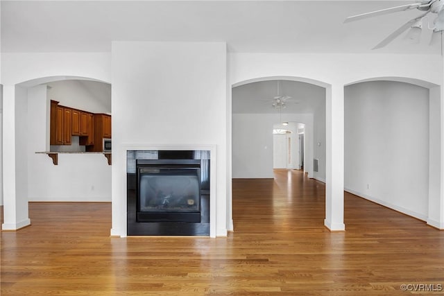 4905 Old Millrace Pl, Glen Allen, VA 23059 - unfurnished living room with ceiling fan, light wood-type flooring, and arched walkways