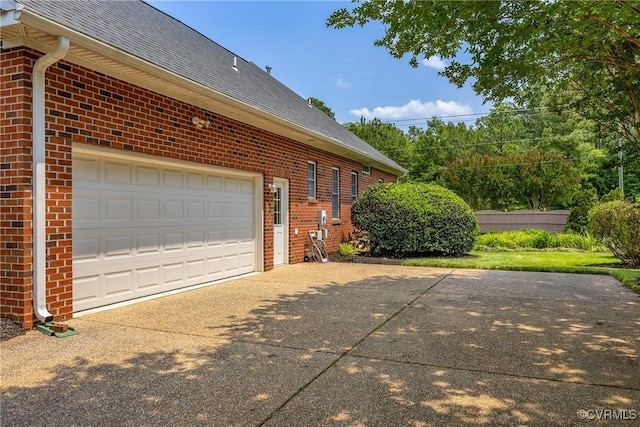 4905 Old Millrace Pl, Glen Allen, VA 23059 - view of property exterior featuring brick siding, driveway, roof with shingles, and a garage