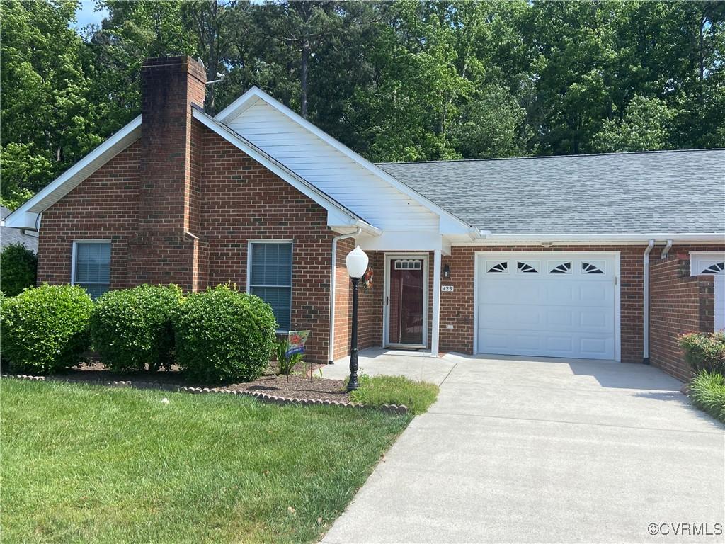 423 Cobblestone Dr, Hopewell, VA 23860 - ranch-style home featuring brick siding, a chimney, an attached garage, driveway, and roof with shingles