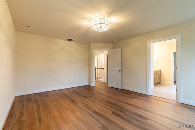 207 Eliza Ln, Aylett, VA 23009 - unfurnished bedroom featuring wood finished floors, baseboards, a chandelier, and ensuite bathroom