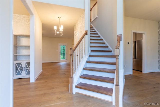 207 Eliza Ln, Aylett, VA 23009 - staircase featuring wood finished floors, baseboards, and a chandelier