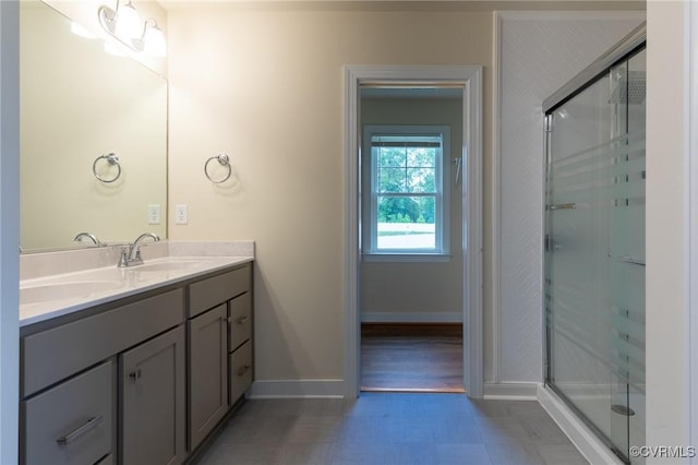 207 Eliza Ln, Aylett, VA 23009 - bathroom featuring double vanity, baseboards, and a stall shower
